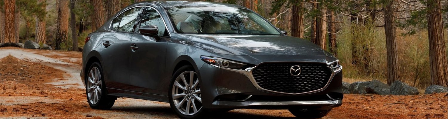 2019 Mazda3 in Colorado Springs Bob Penkhus Mazda Motor City.png 2019 Mazda3 sedan parked on a road covered in pine straw in a forest