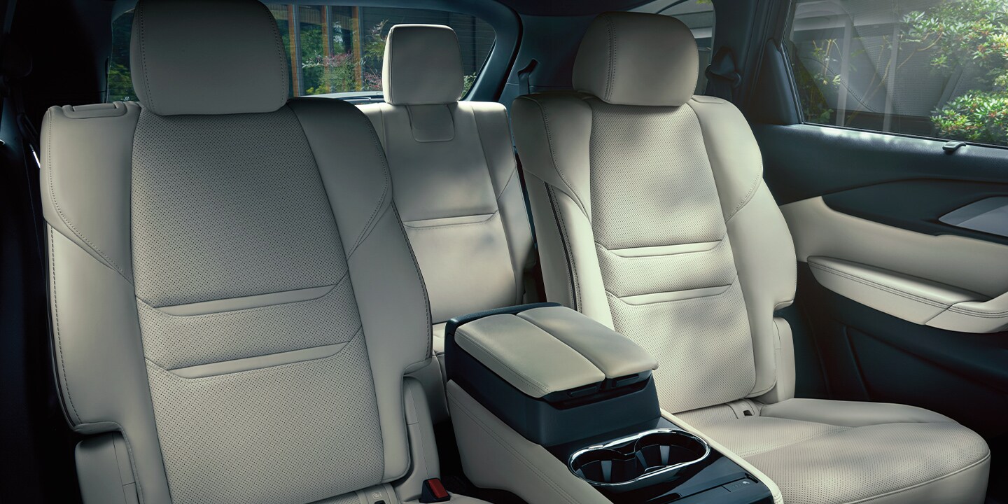 2020-mazda-cx-9-bob-penkhus-mazda-dealership-colorado.jpg The white leather interior of a 2020 Mazda CX-9. A wooded area can be seen from the rear windows