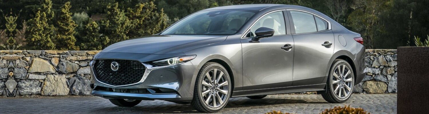 2019 Mazda3 sedan in Colorado Springs Bob Penkhus Dealerships.png Driver side exterior of a machine gray 2019 Mazda3 sedan parked in an affluent driveway