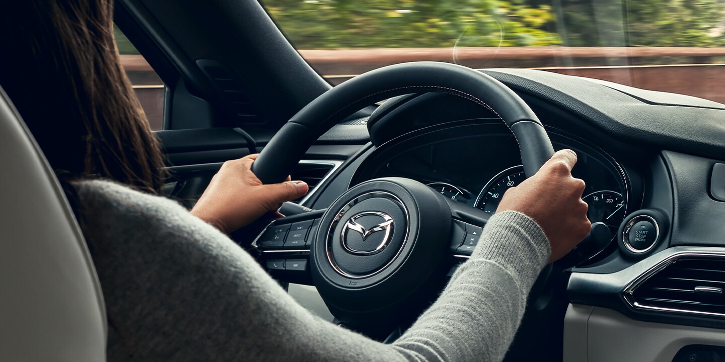 2020-mazda-cx-9-bob-penkhus-dealership-colorado-springs.jpg Interior view from the backseat of a woman driving a 2020 Mazda CX-9