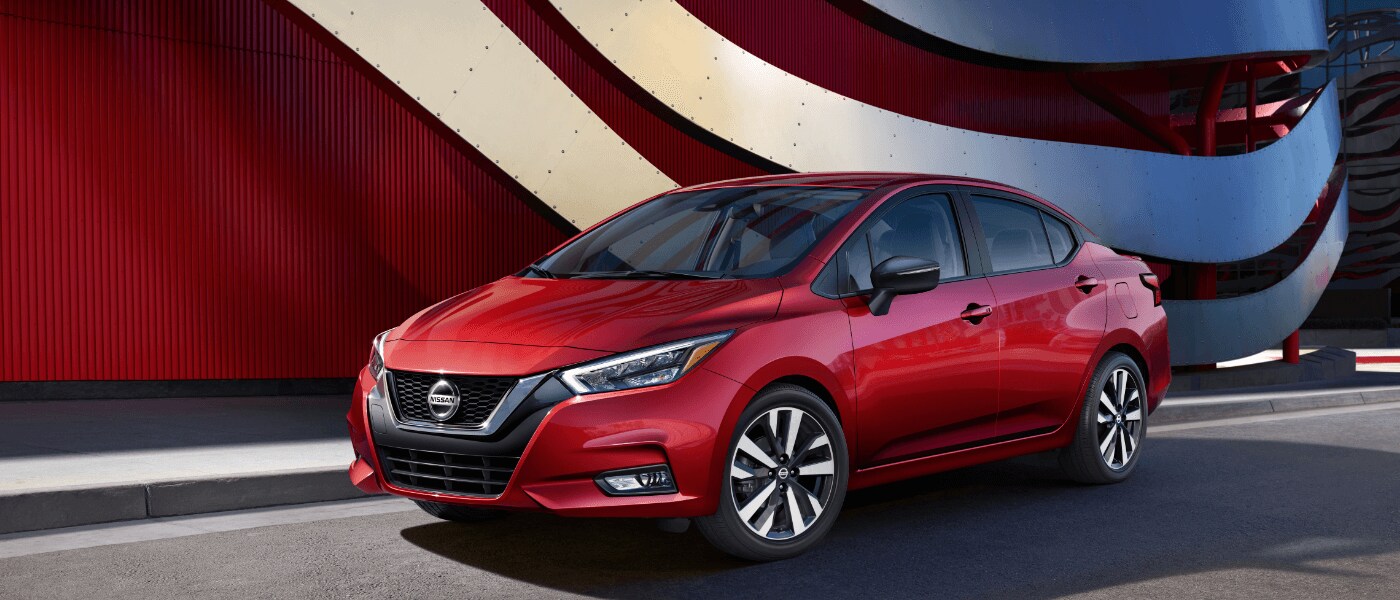 2020 Nissan Versa in red parked infront of res art sculpture .png