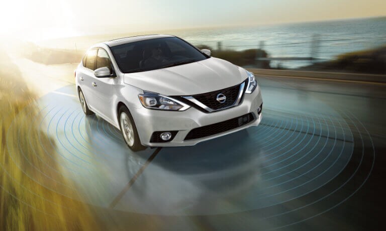2019 Nissan Sentra in white driving on highway showing the saftey sensors