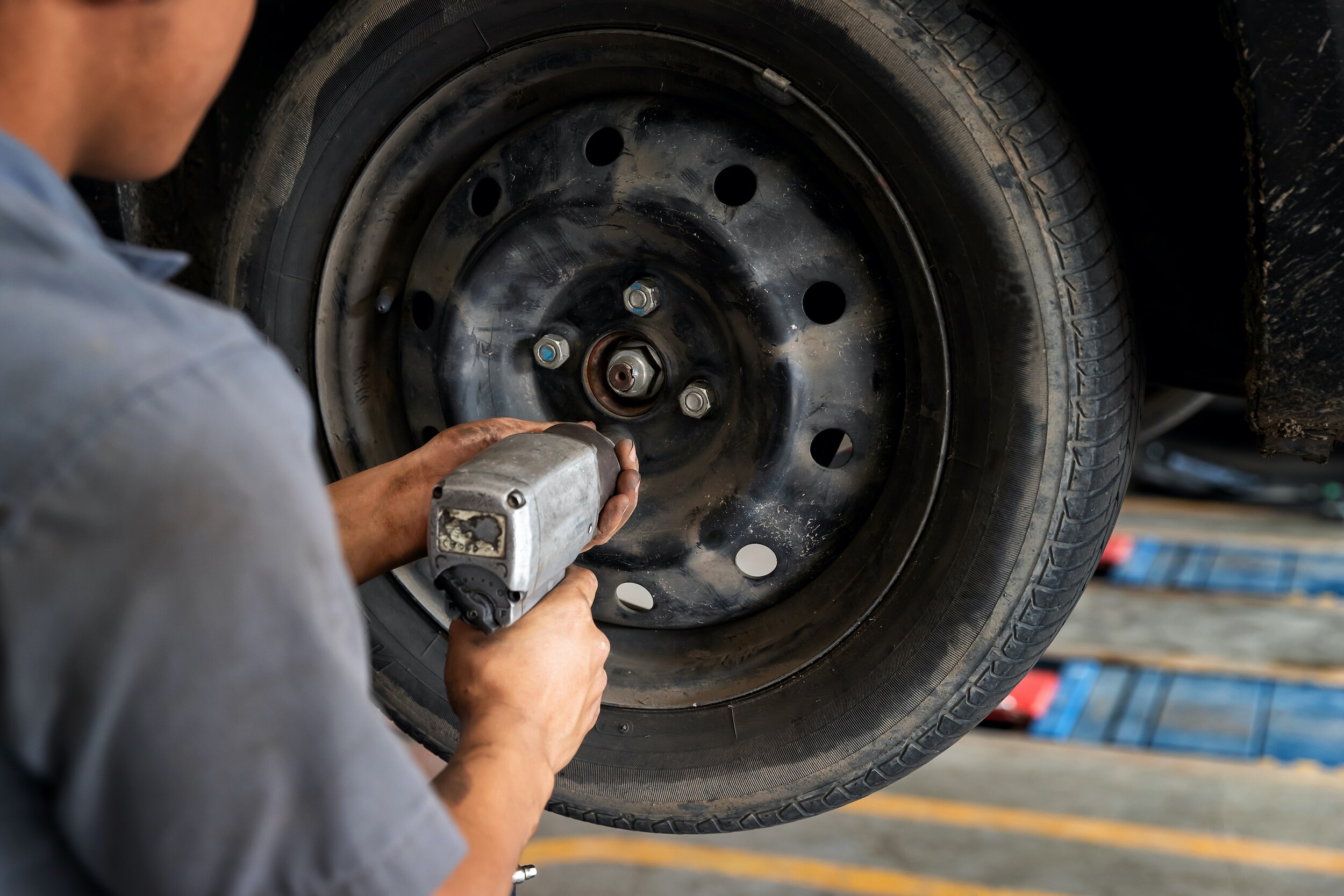 How to rotate your vehicle tires at Boch Auto Group in Massachusetts | Mechanic removing tire