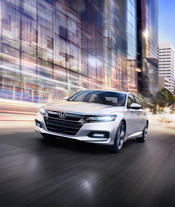 Boch Honda West is a Family Owned Dealership near Groton, MA | 2020 Honda Accord driving through colorful city