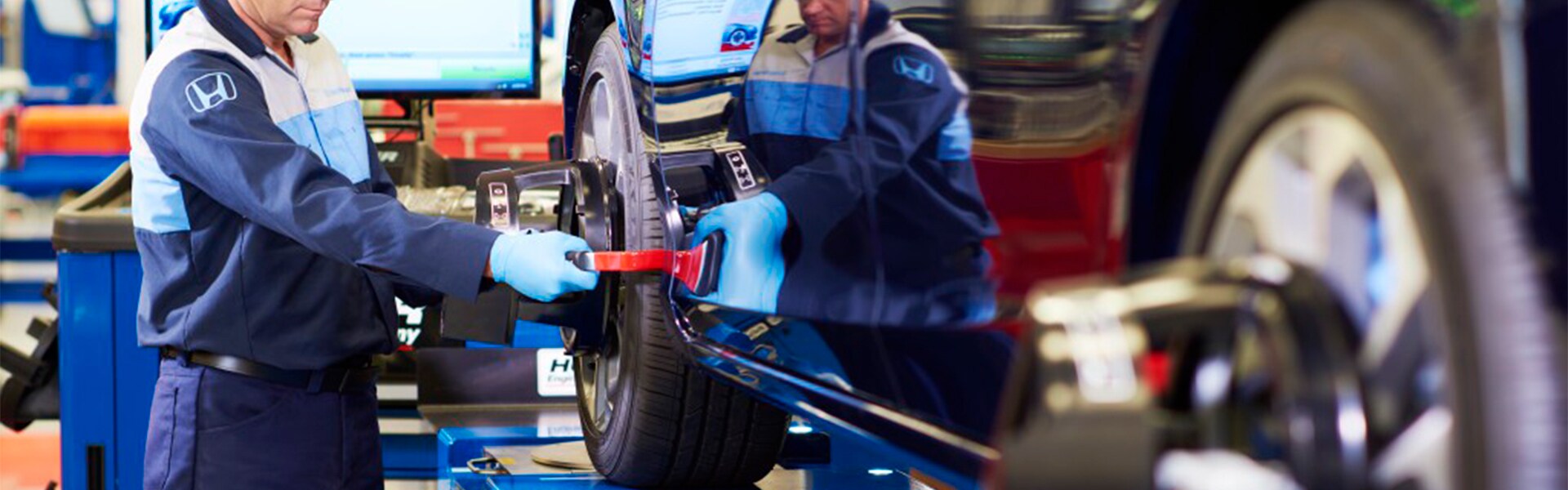 Boch Honda West is a Family Owned Dealership near Acton, MA | Honda Service Advisor Realigning Tires on Honda Vehicle Boch Honda West is a Family Owned Dealership near Acton, MA | Honda Service Advisor Realigning Tires on Honda Vehicle
