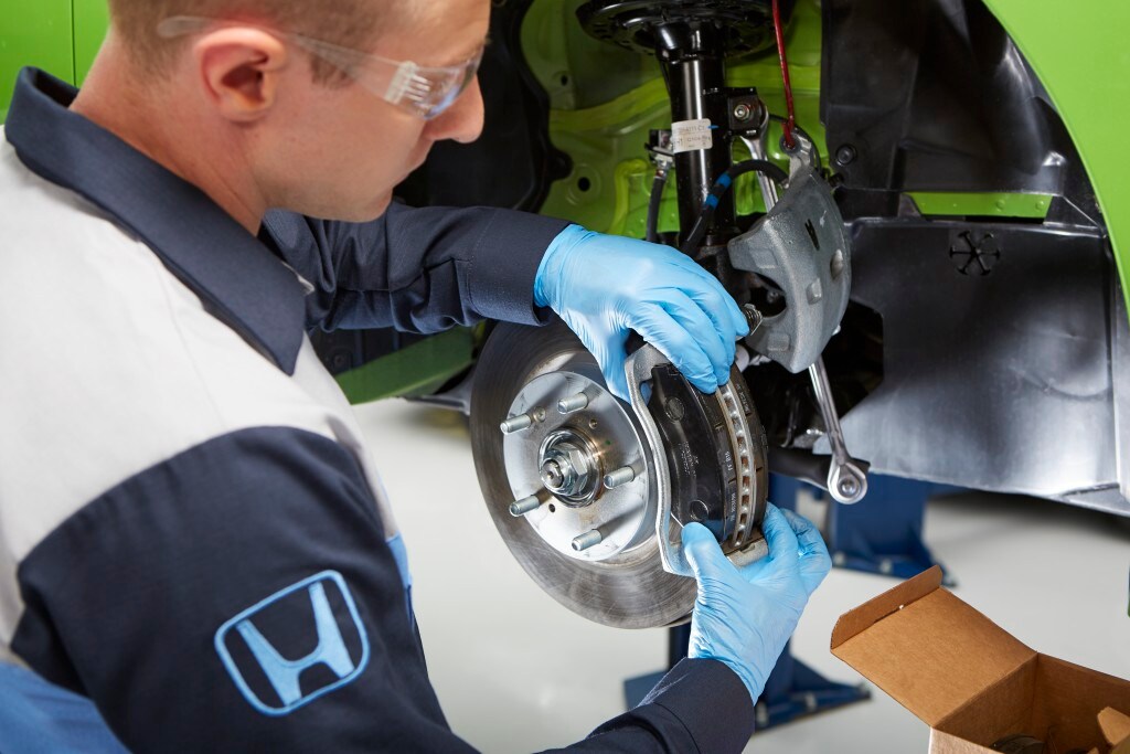Boch Honda West is a Family Owned Dealership near Chelmsford, MA | Honda service advisor fixing brakes on a Honda vehicle