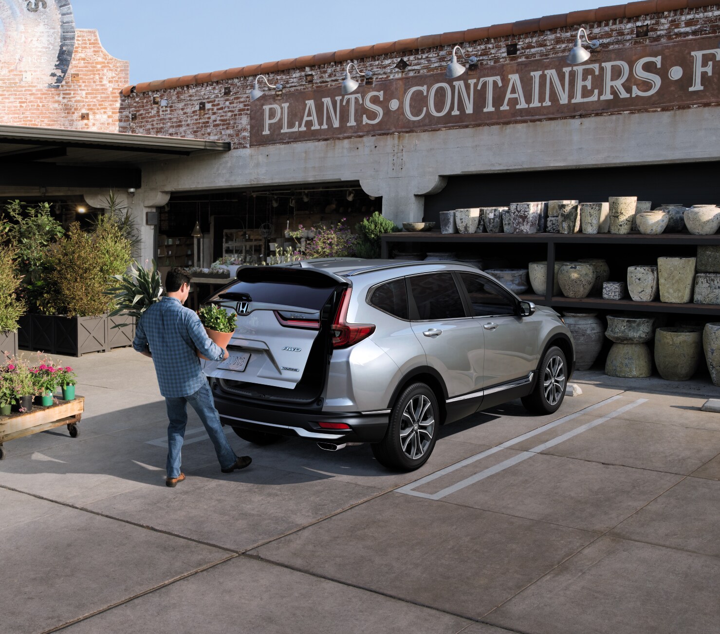 Boch Honda West is a Family Owned Dealership near Chelmsford, MA | Man opening trunk of Silver 2020 Honda CR-V