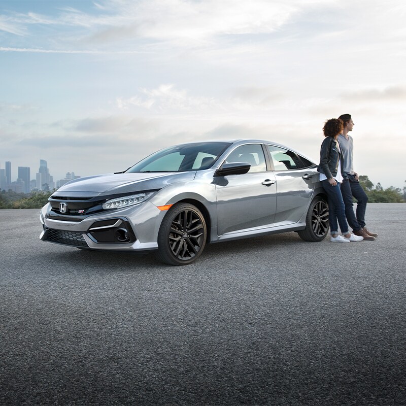 Boch Honda West is a Family Owned Dealership near Boxborough, MA | Young couple leaning against 2020 Honda Civic