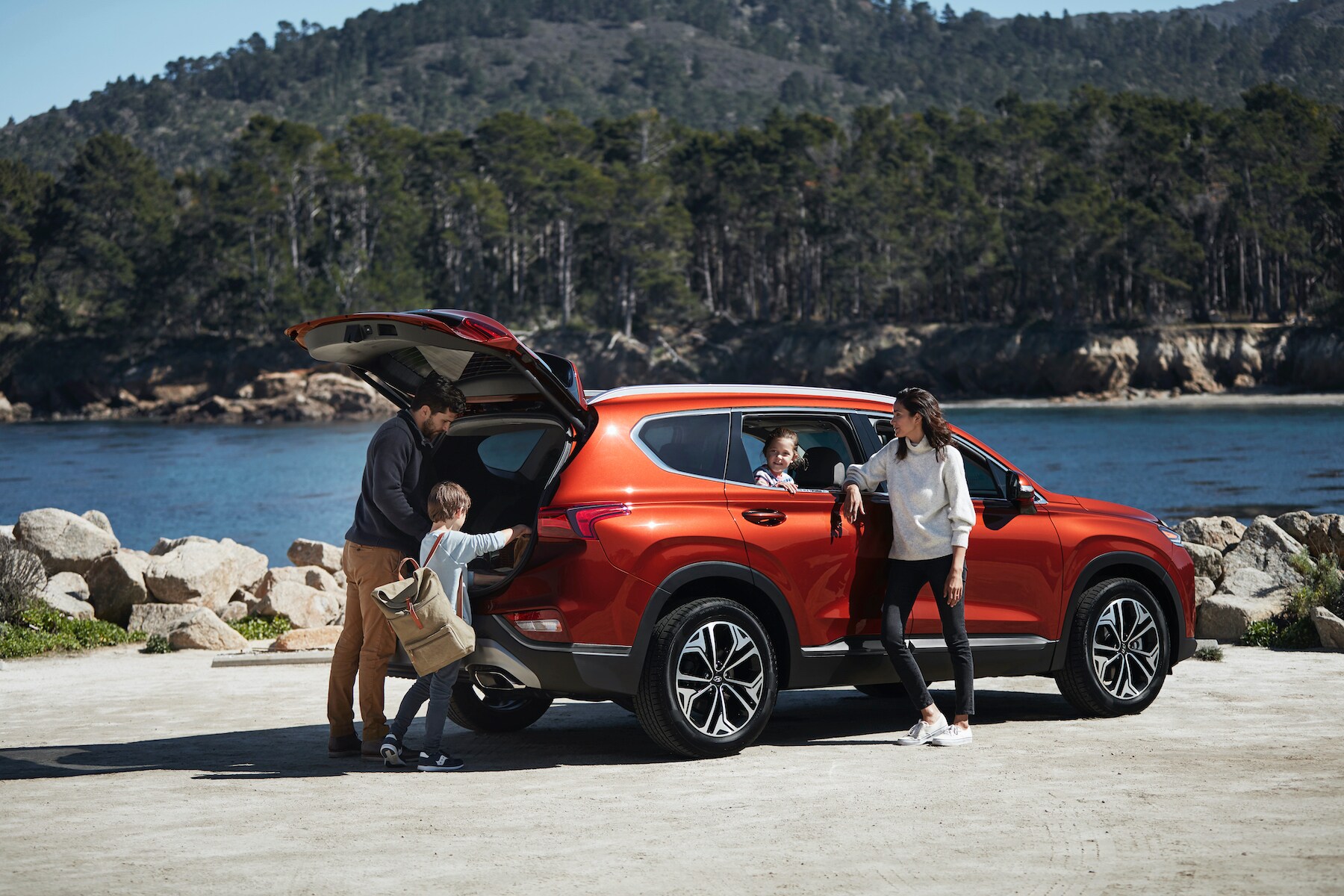 Boch Hyundai is a Luxury Car Dealership near Stoughton, MA | Orange 2020 Hyundai Tucson being unpacked by family