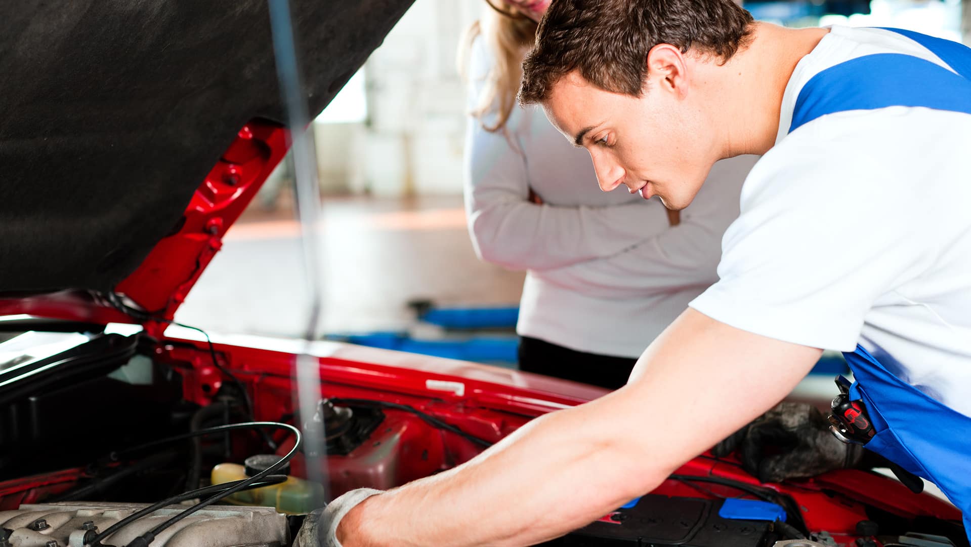 Boch Nissan is a Car Dealership near Canton, MA | Nissan Service Technician working under the hood