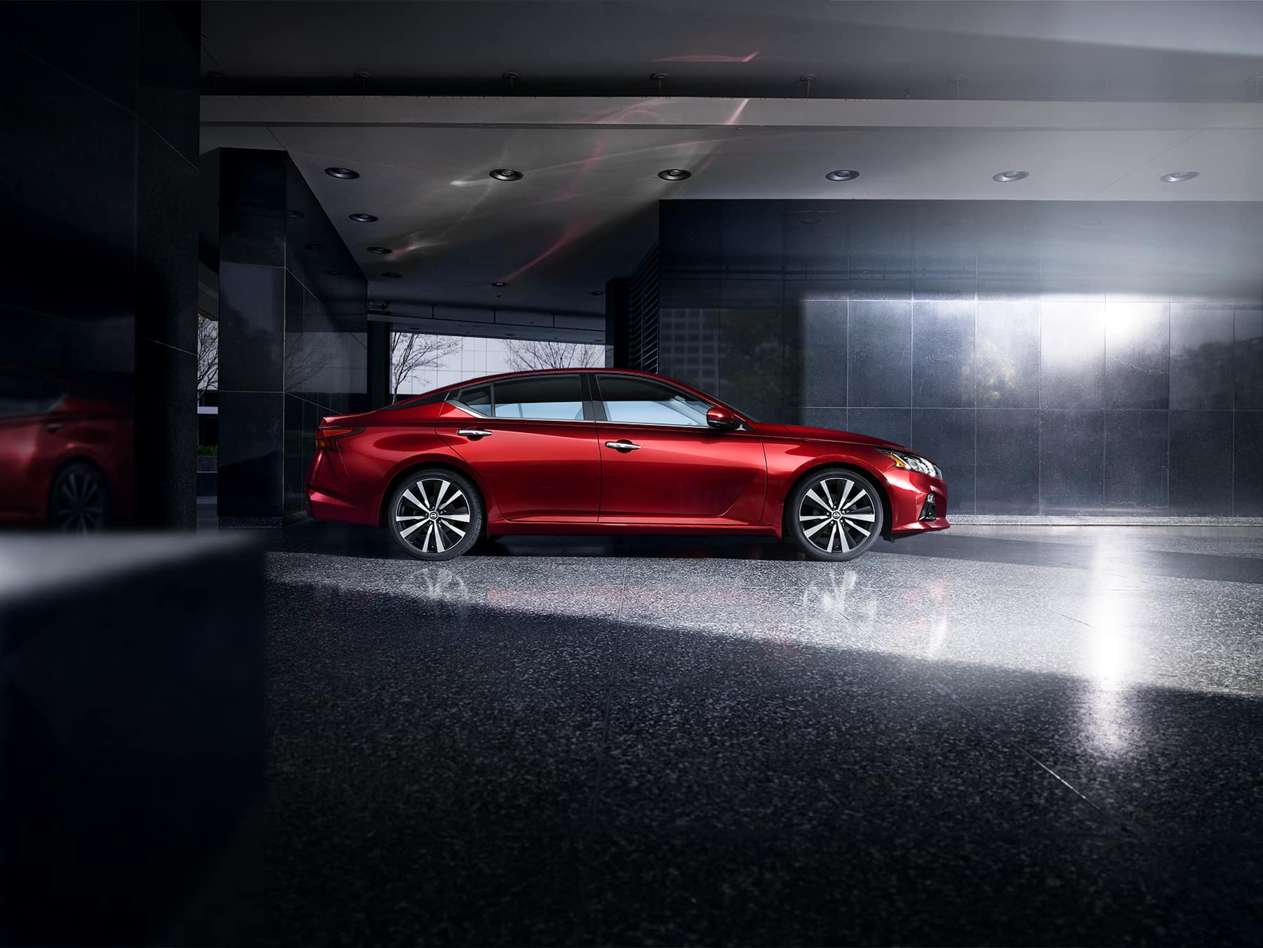 Boch Nissan is a Car Dealership near Canton, MA | Red 2020 Nissan Altima parked in building