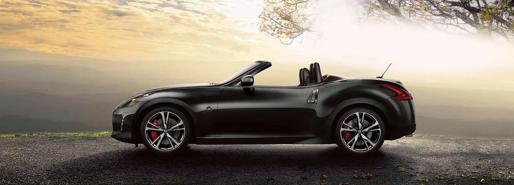 Boch Nissan is a Car Dealership near Canton, MA | Black 2019 Nissan 370Z Convertable parked at sunset