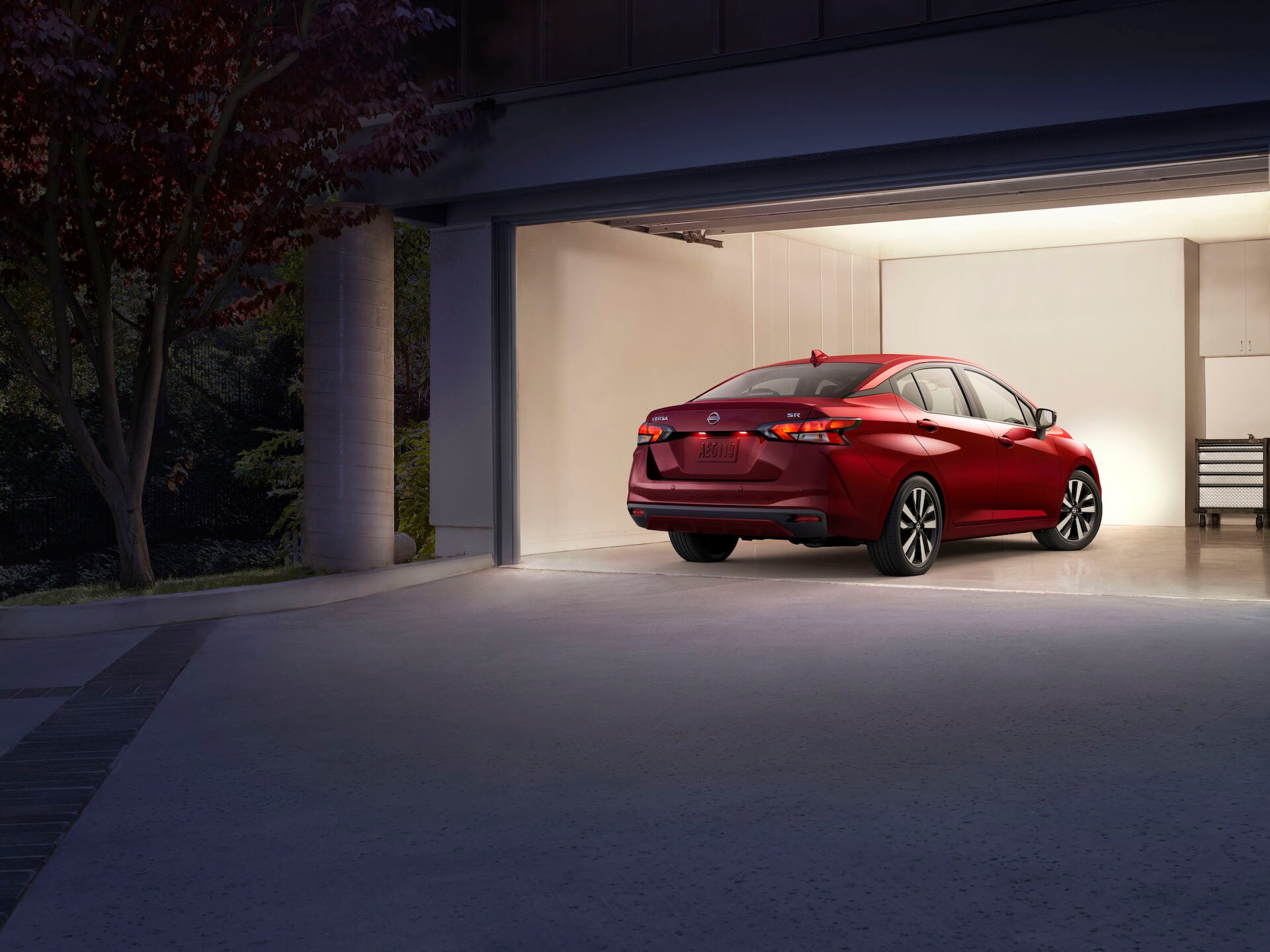 Boch Nissan South is a Family Owned Dealership near Lincoln, MA | Red 2020 Nissan Versa parked in garage at night