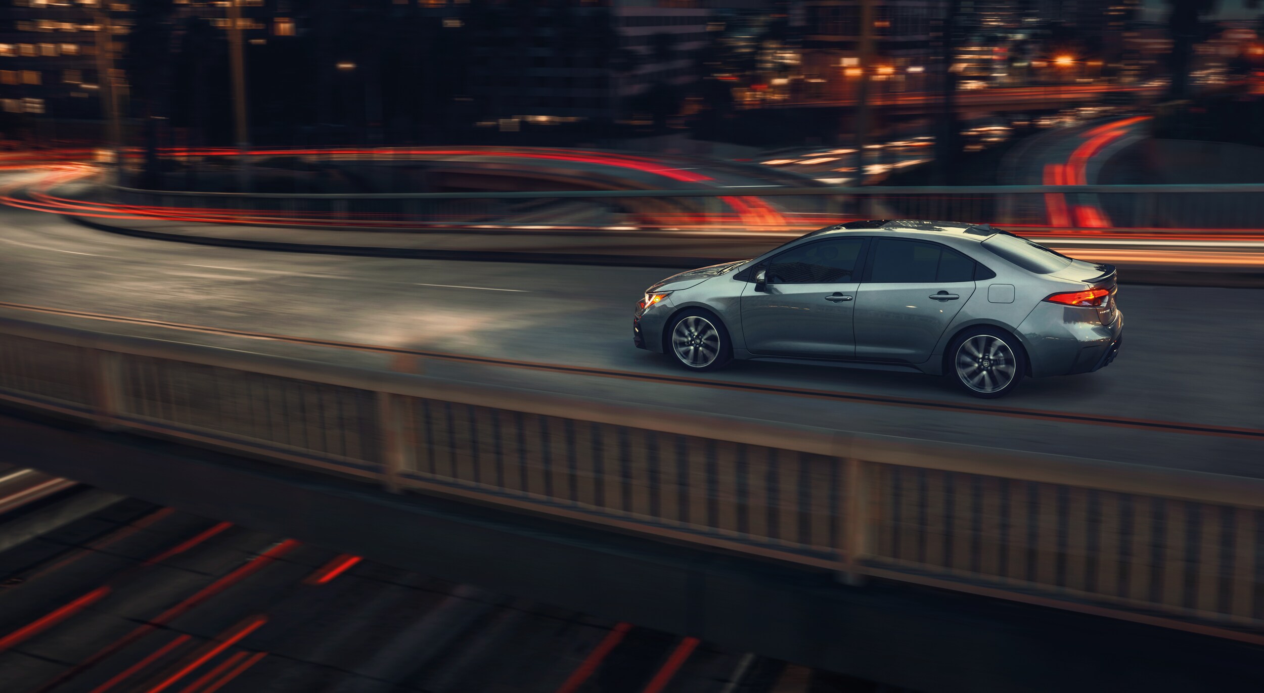 Boch Toyota is a Family Owned Dealership near Boston, MA | 2020 Toyota Corolla driving on city skyway at night