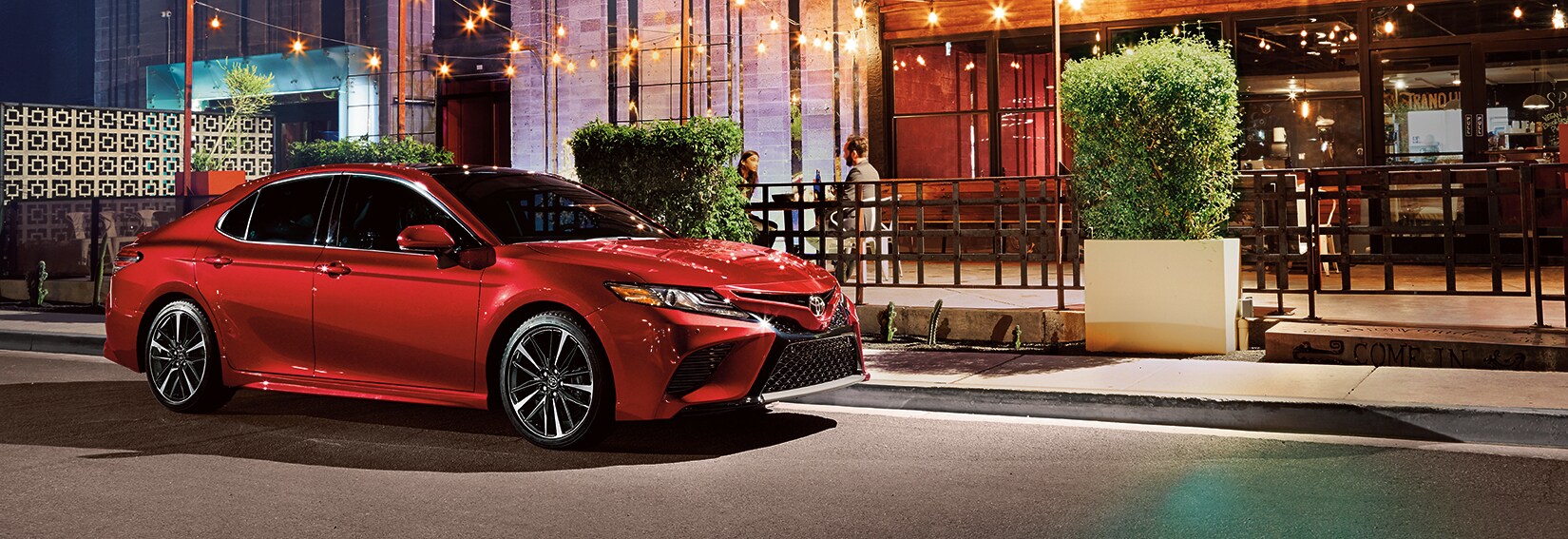 Boch Toyota is a Family Owned Dealership near Boston, MA | 2020 Toyota Camry parked outside of restaurant at night