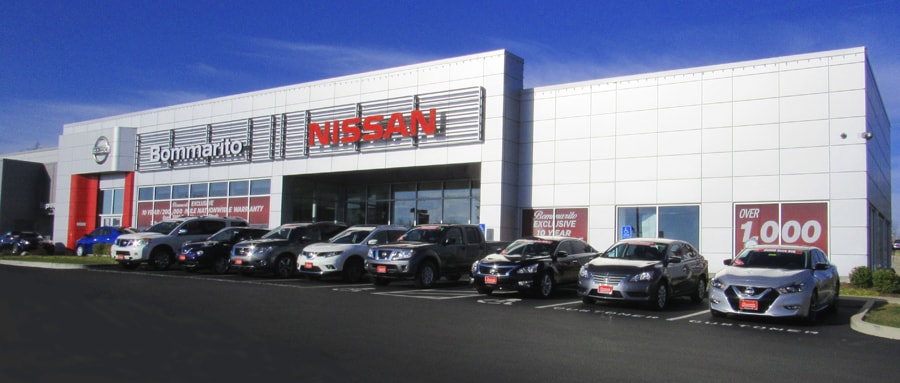 Buy your next new or used car at Bommarito Nissan of Ballwin near St. Louis, MO! New Nissan cars in front of the Bommarito Nissan of Ballwin dealership.