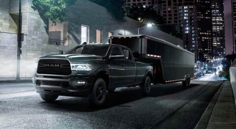 2021 RAM 2500-TRX carrying trailer through city streets at night