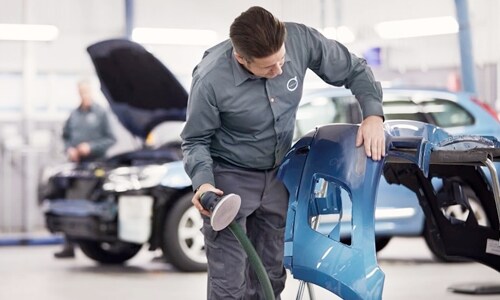 Official Volvo service tech working on a bumper