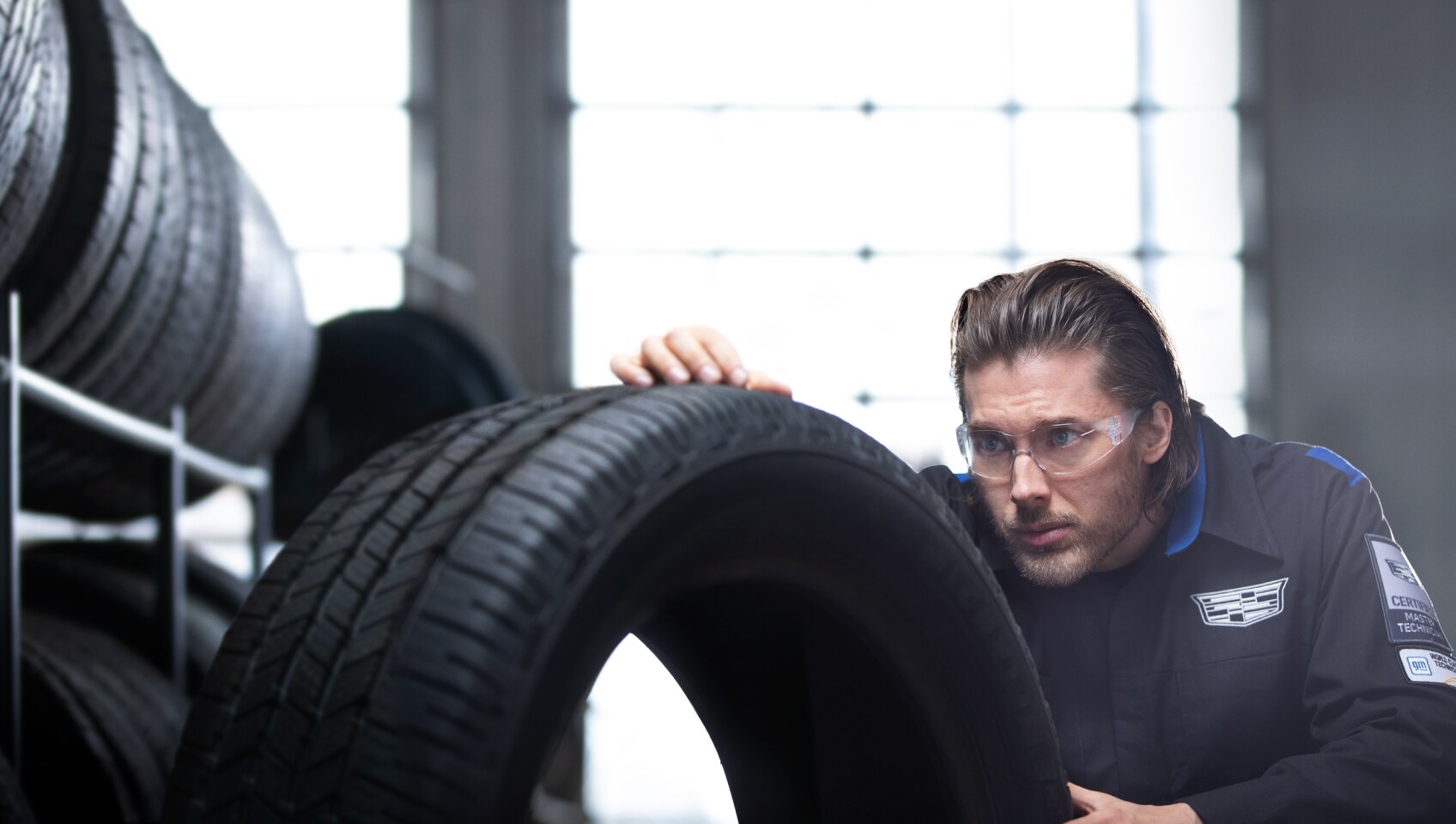 Service worker inspecting tires
