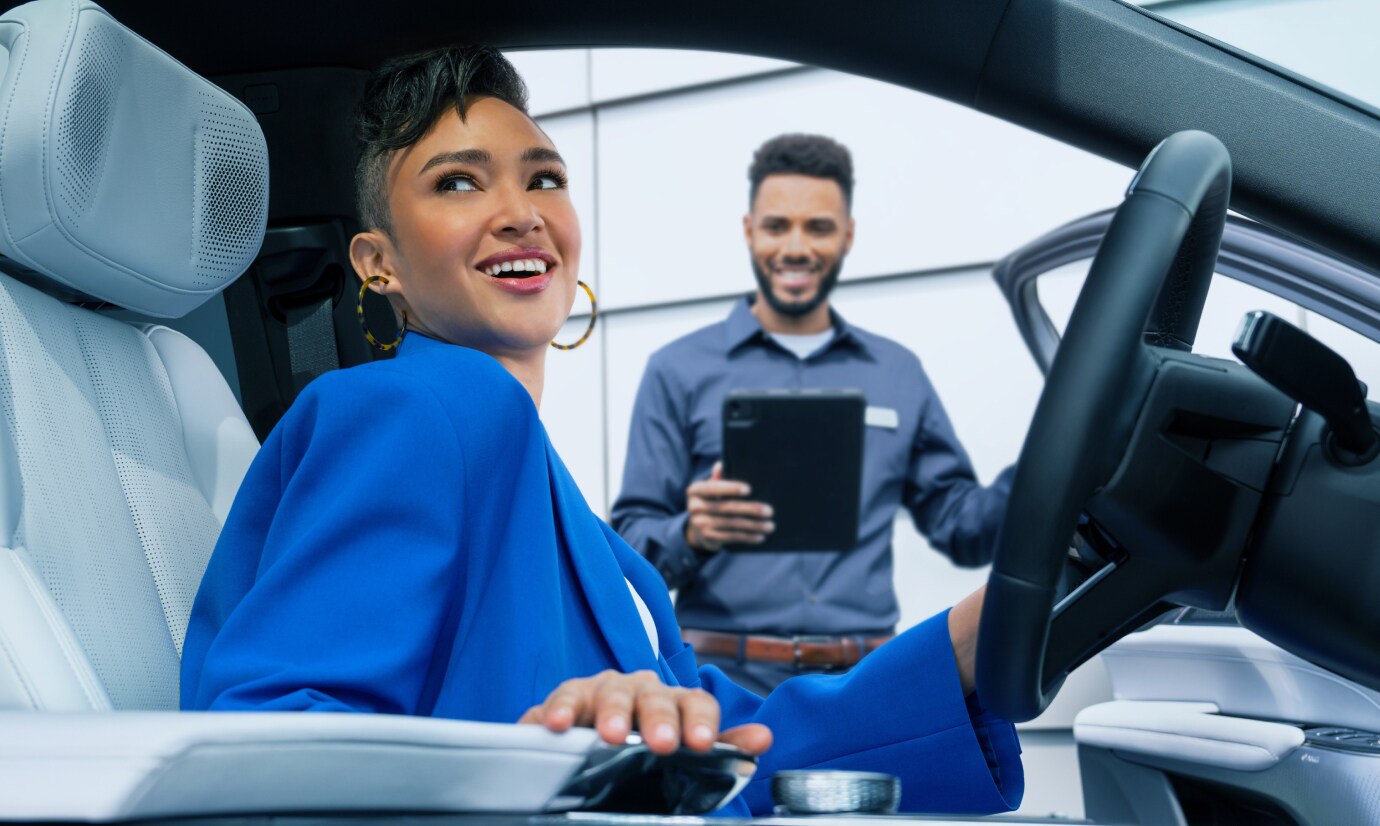 Smiling customer sitting in a Cadillac