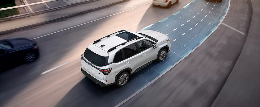 White 2026 Subaru Forester Hybrid traveling on a highway behind another vehicle, with the adaptive cruise lane highlighted
