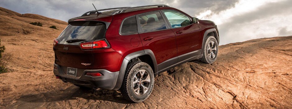 Red 2018 Jeep Cherokee ascending a rocky hill