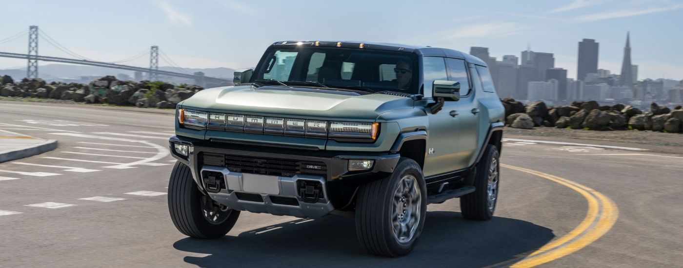 The green 2025 GMC Hummer EV from the front.