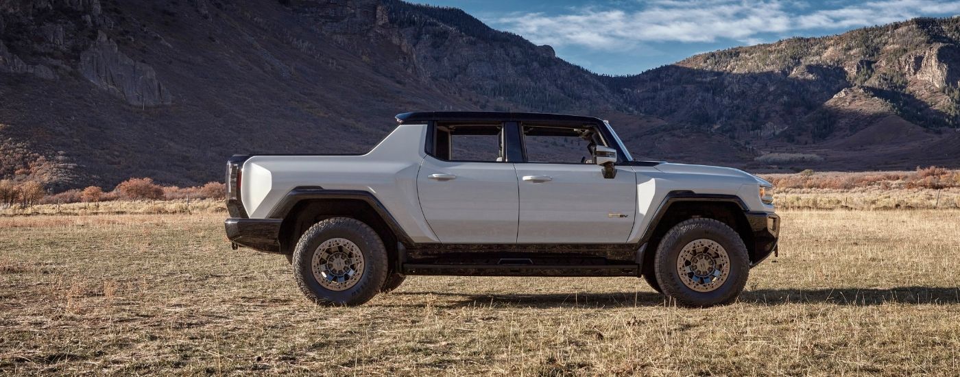 A grey 2025 GMC Hummer EV from the side.