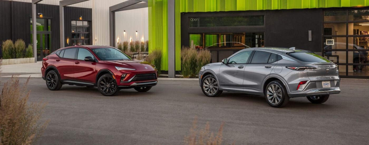 2024 Buick Envista ST & Avenir - Duo.jpg A red and a silver 2024 Buick Envista ST parked outside a Buick dealer near Doral