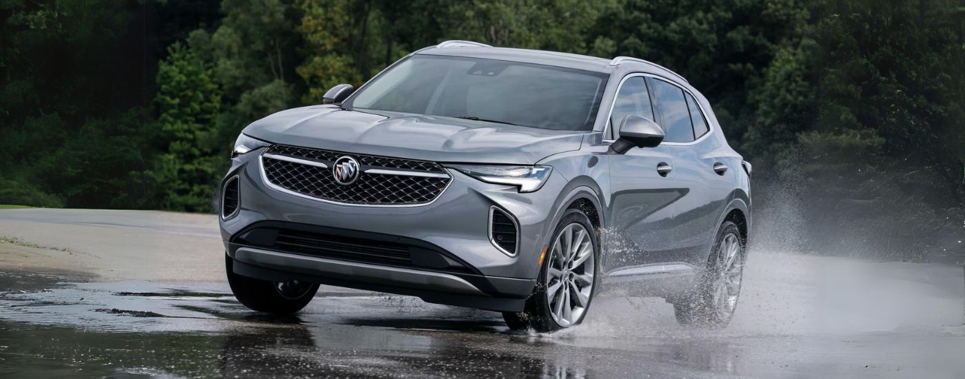 2023%20Buick%20Envision%20Avenir%20-%20Wet.jpg Silver 2023 Buick Envision Avenir driving to a Buick dealer near Fort Lauderdale