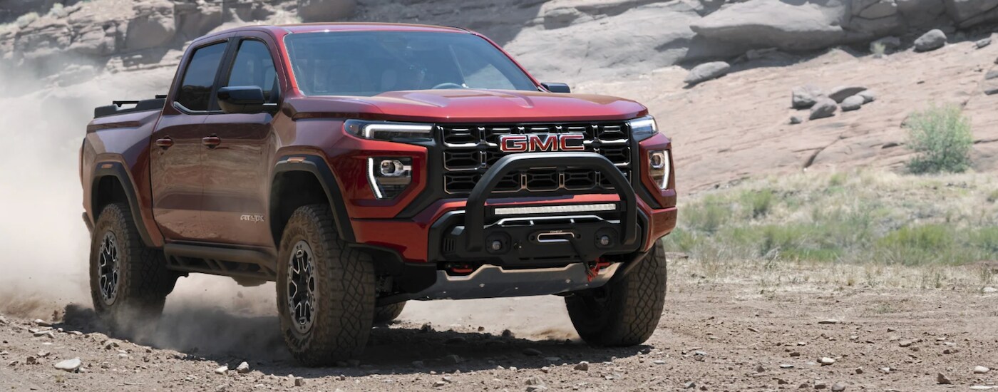 2023%20GMC%20Canyon%20-%20red.png Red 2023 GMC Canyon AT4X driving down a trail