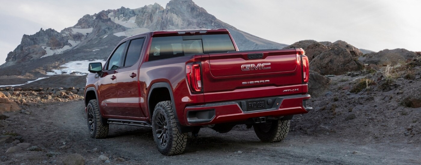A red 2024 GMC Sierra 1500 from the rear at an angle.