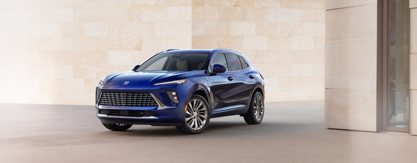 Blue 2026 Buick Envison for sale near Princeton parked near a brick wall.