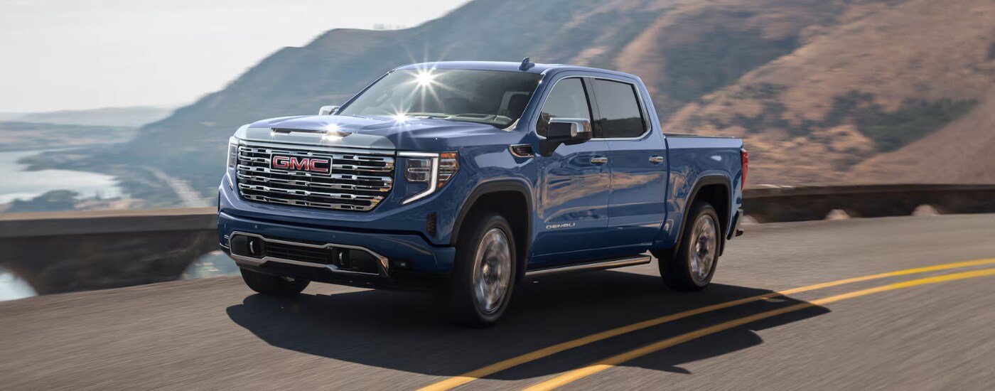 2026%20GMC%20Sierra%201500%20-%20water.png Blue 2026 GMC Sierra 1500 Denali driving along a coast