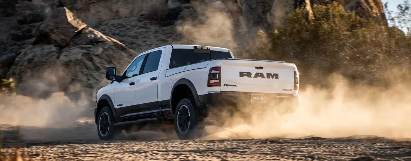 2023%20Ram%202500%20Rebel%20-%20Dust.jpg White 2023 Ram 2500 driving off-road