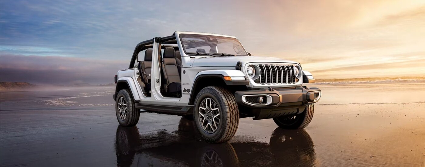 A white 2025 Jeep Wrangler from the front at an angle.