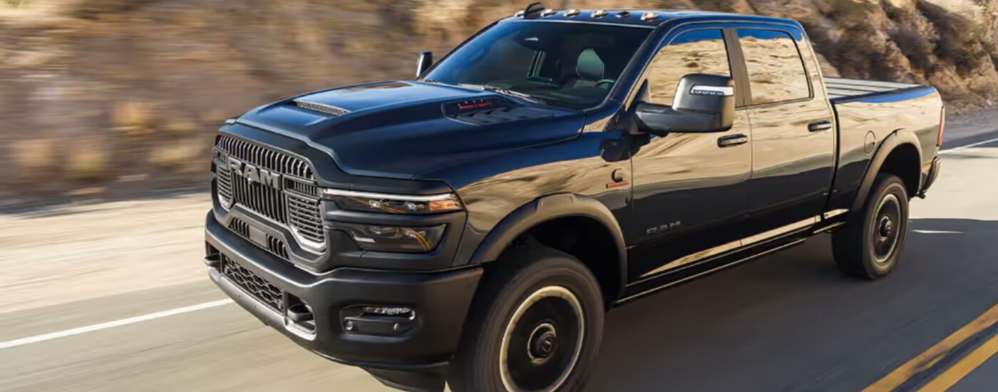 2026 Ram 2500 - side.png Black 2026 Ram 2500 driving to a Ram dealer near North Miami Beach