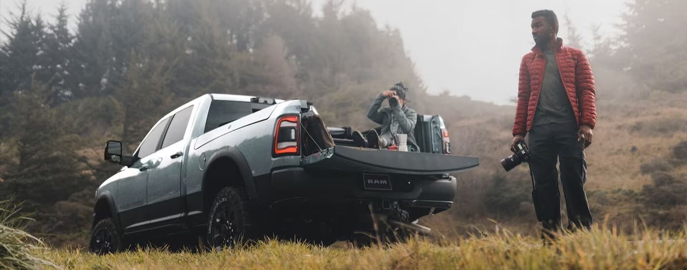 2024%20Ram%202500%20-%20Camera.jpg Silver 2024 Ram 2500 with people taking photos