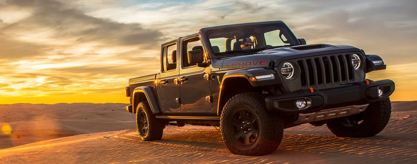 2020%20Jeep%20Gladiator.jpg Black 2020 Jeep Gladiator Mojave parked on a sand dune