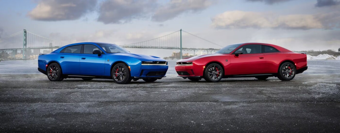 2026 Dodge Charger - duo.png An orange and a blue 2026 Dodge Charger's facing each other