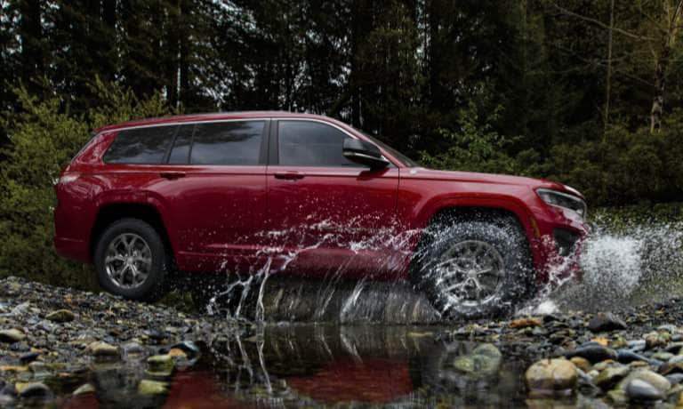 2025 Jeep Grand Cherokee L offroading in a stream