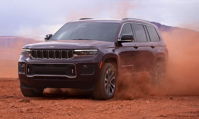 2025 Jeep Grand Cherokee L kicking up red dust