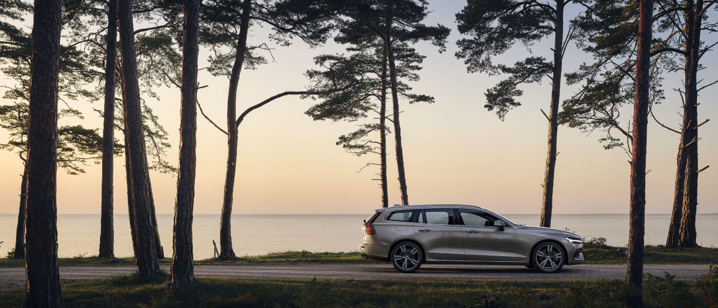 Volvo V60 side profile view driving by water