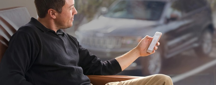 man holding phone accessing Uconnect