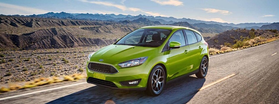 Test Drive a 2018 Ford Focus Today A green 2018 Ford Focus driving down the open road
