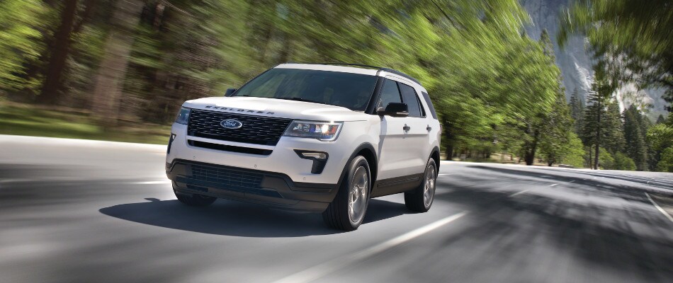 What is Ford EcoBoost A white 2018 Ford Explorer driving down a road