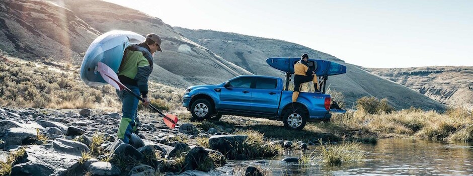 2019 Ford Ranger Capability Two men bringing their kayaks to their blue 2019 Ford Ranger