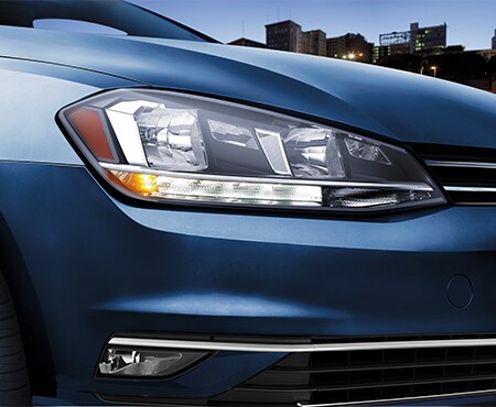 Close-Up of Headlights on Blue Volkswagen Golf