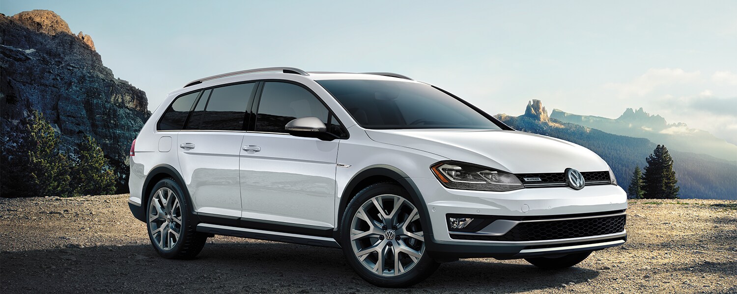 White Volkswagen Golf Alltrack parked on stone