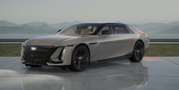 A beige Cadillac CELESTIQ parked on an extremely shiny floor in front of a plate glass window A beige Cadillac CELESTIQ parked on an extremely shiny floor in front of a plate glass window